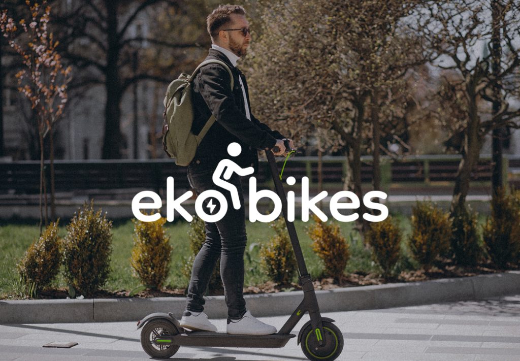 eko bikes logo overlaid on a photo of a man riding an electric scooter in a park