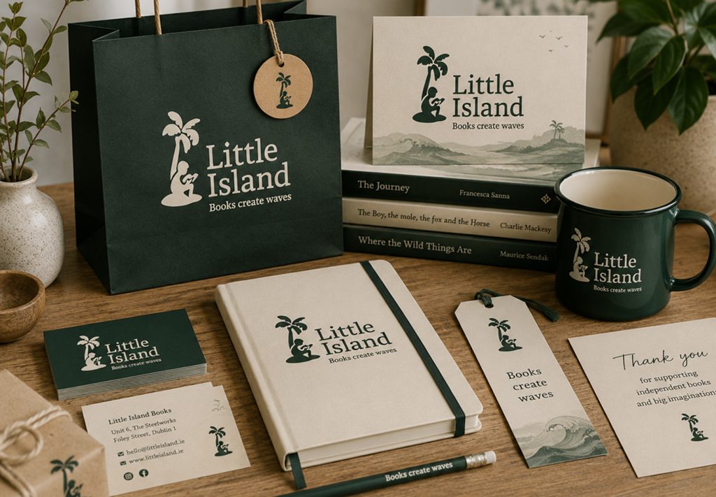 Little Island tote bag, mug, notebook and stationery beside a stack of children's books