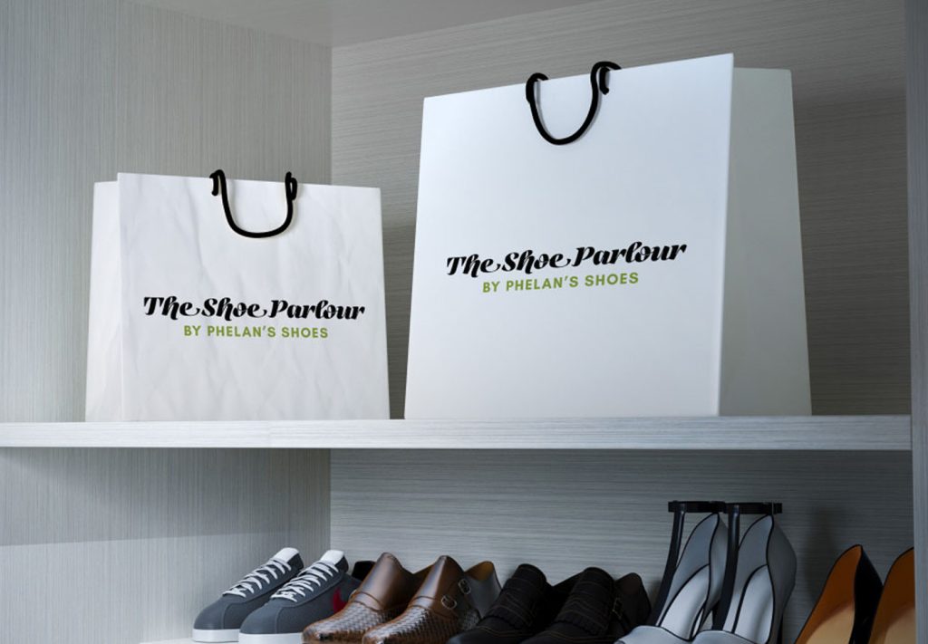 The Shoe Parlour by Phelan's Shoes branded bags on a shelf beside shoe displays